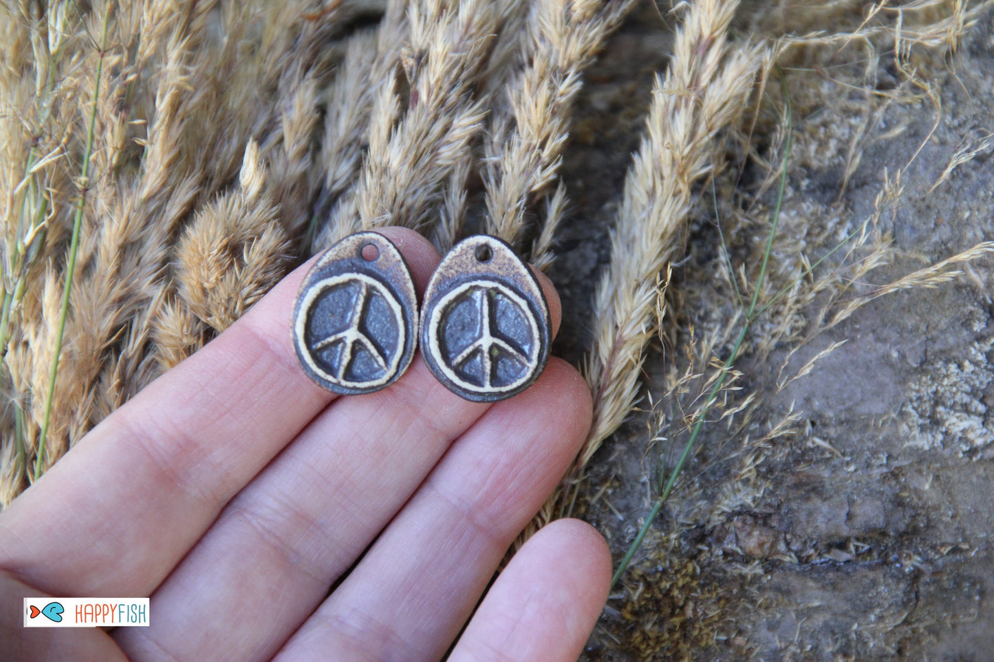 A pair of PEACE ceramic earring dangles