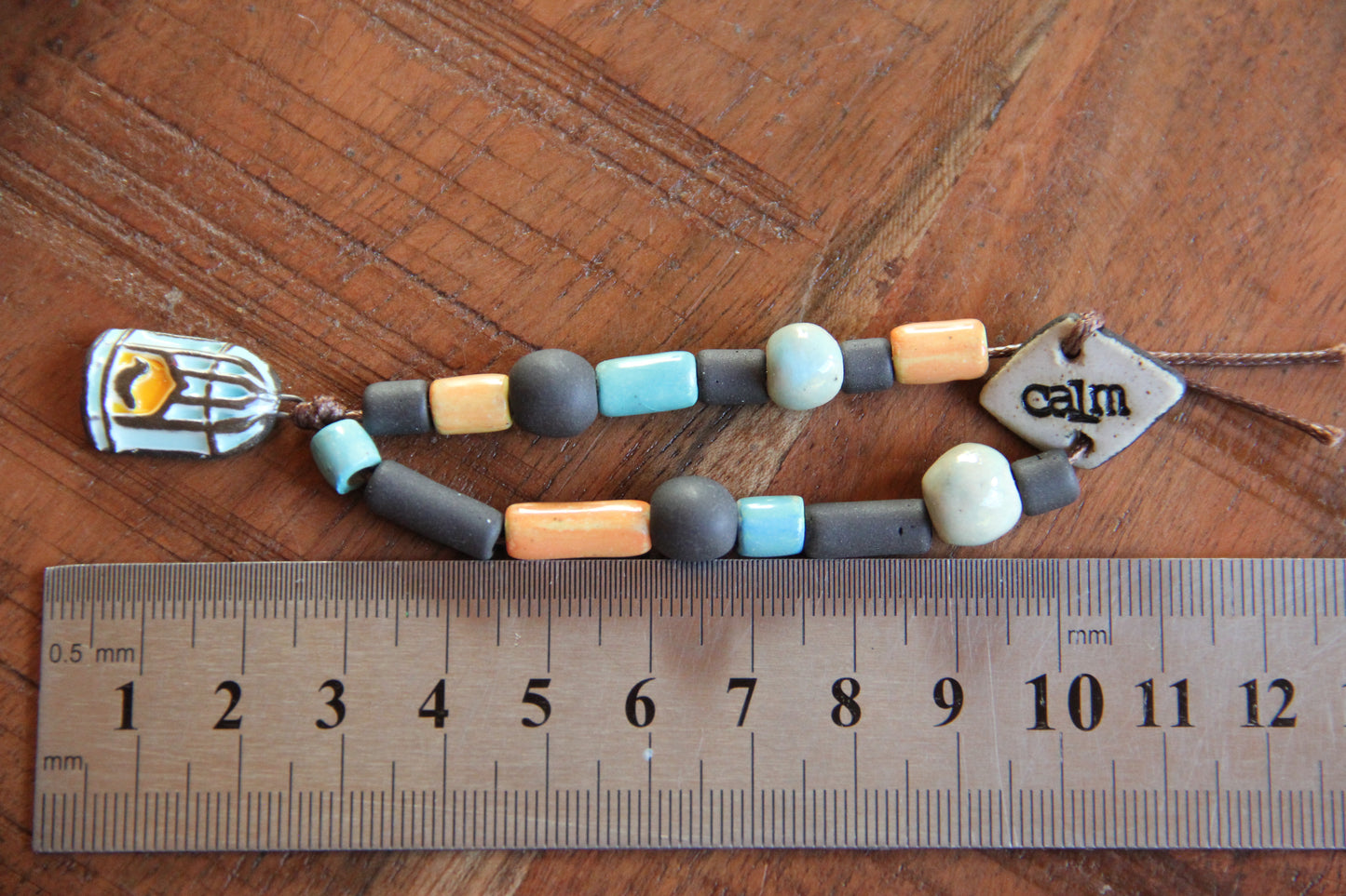 CALM - Bracelet set with a charm BIRD WITH CAGE DOOR OPENED