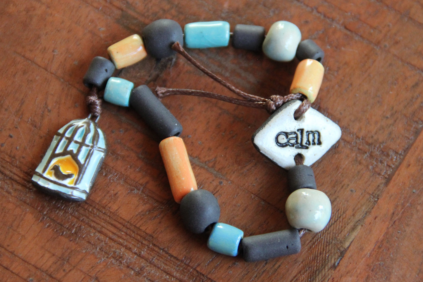 CALM - Bracelet set with a charm BIRD WITH CAGE DOOR OPENED