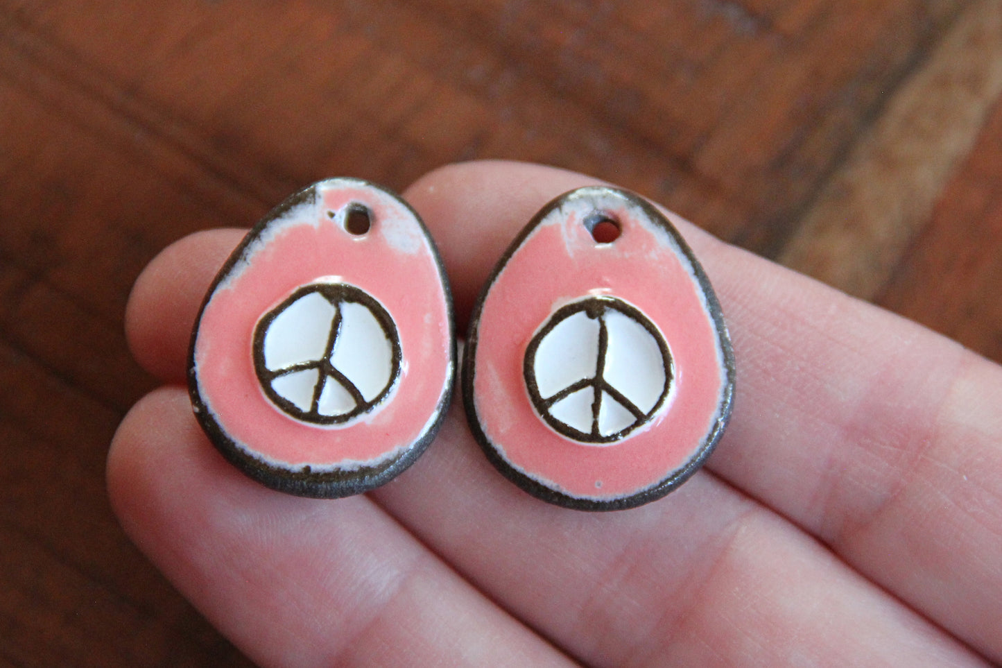 A pair of PEACE ceramic earring dangles