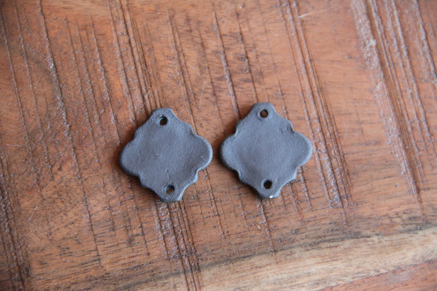 A pair of PEACE ceramic CONNECTORS