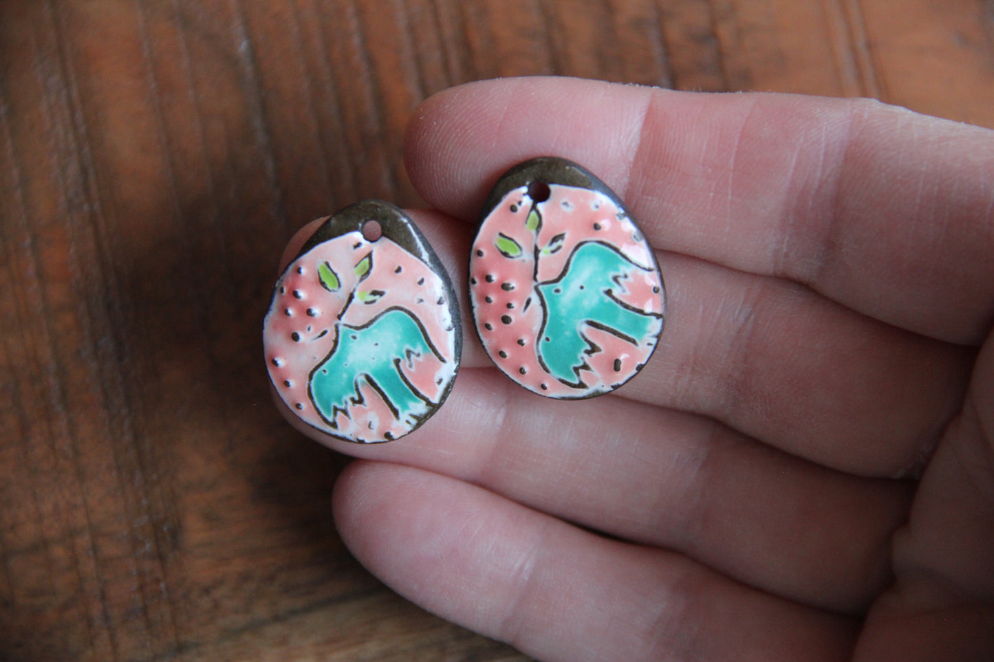 A pair of PEACE DOVE ceramic earring dangles