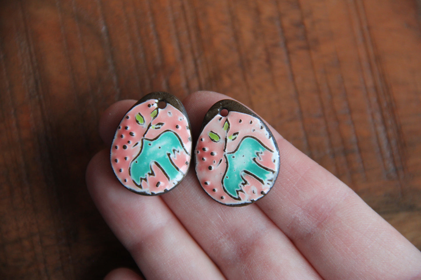 A pair of PEACE DOVE ceramic earring dangles