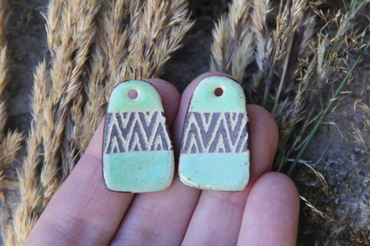 A pair of rustic flat ceramic earring dangles