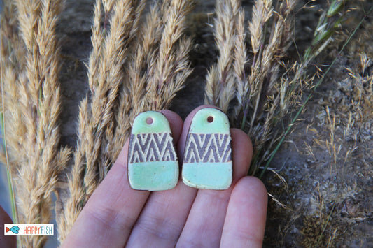 A pair of rustic flat ceramic earring dangles