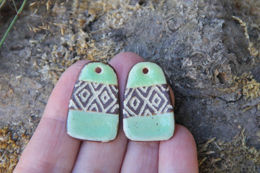 A pair of rustic flat ceramic earring dangles