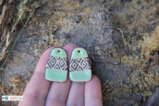 A pair of rustic flat ceramic earring dangles