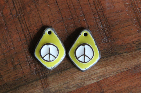 A pair of PEACE ceramic earring dangles