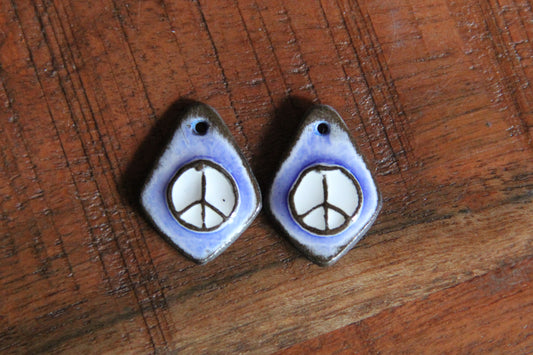 A pair of PEACE ceramic earring dangles