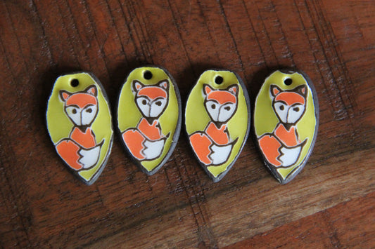 A pair of ceramic earring dangles with foxes