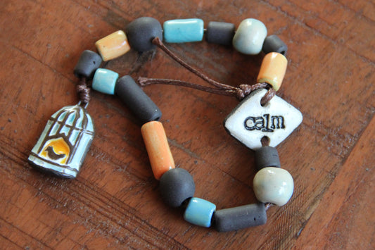 CALM - Bracelet set with a charm BIRD WITH CAGE DOOR OPENED