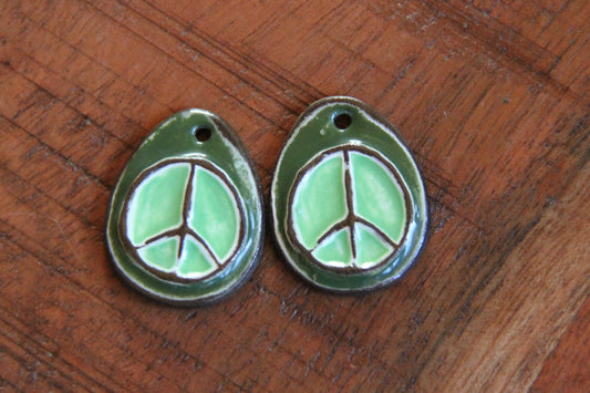 A pair of PEACE ceramic earring dangles