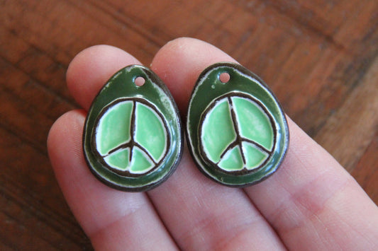 A pair of PEACE ceramic earring dangles