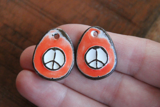 A pair of PEACE ceramic earring dangles