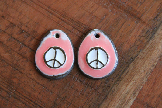 A pair of PEACE ceramic earring dangles