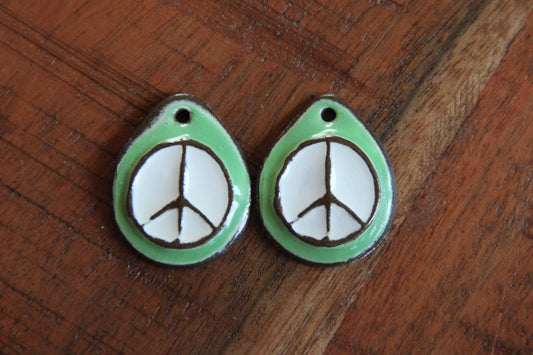 A pair of PEACE ceramic earring dangles