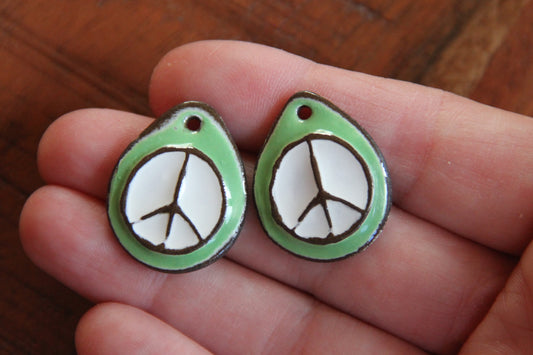 A pair of PEACE ceramic earring dangles