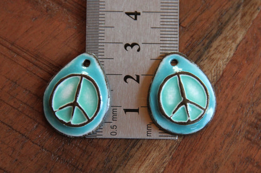 A pair of PEACE ceramic earring dangles