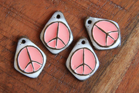 A pair of PEACE ceramic earring dangles