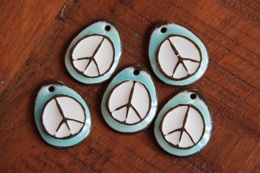 A pair of PEACE ceramic earring dangles