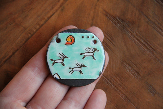 Running horses ceramic pendant