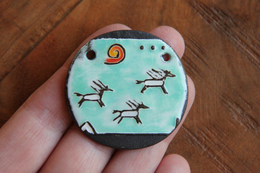 Running horses ceramic pendant