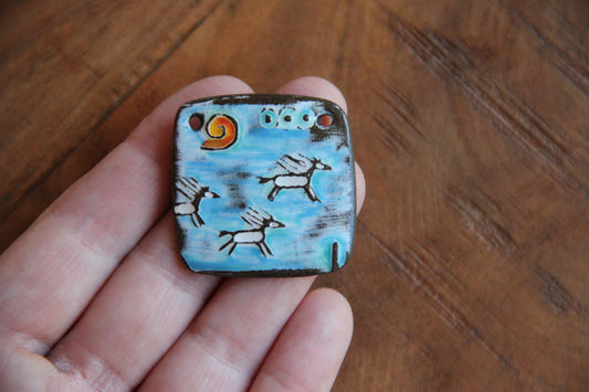 Running horses ceramic pendant