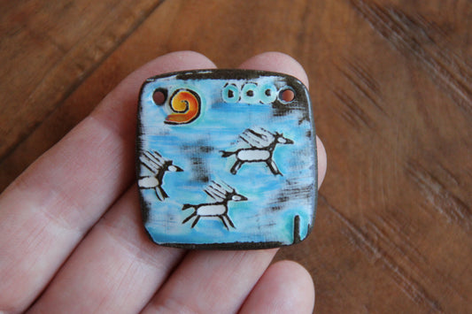 Running horses ceramic pendant