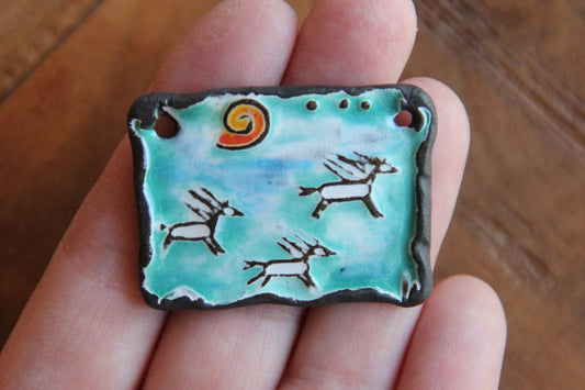 Running horses ceramic pendant