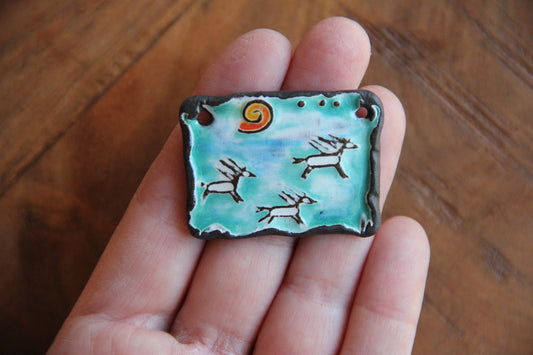 Running horses ceramic pendant