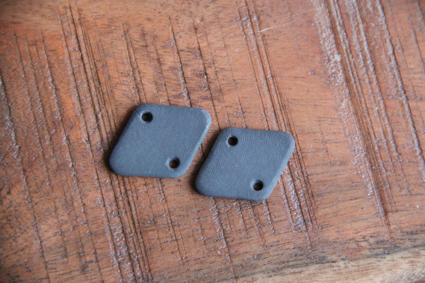 A pair of ceramic CONNECTORS hakuna matata