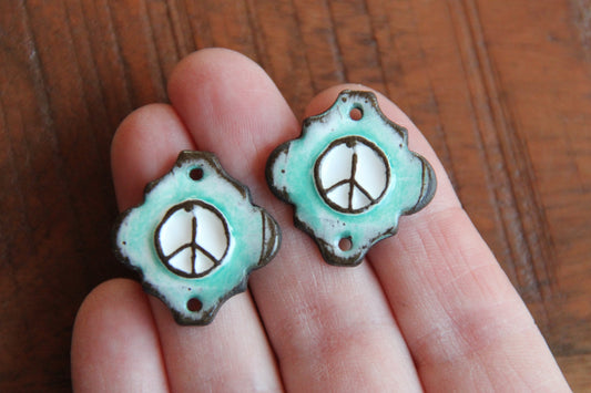 A pair of PEACE ceramic CONNECTORS