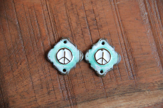 A pair of PEACE ceramic CONNECTORS