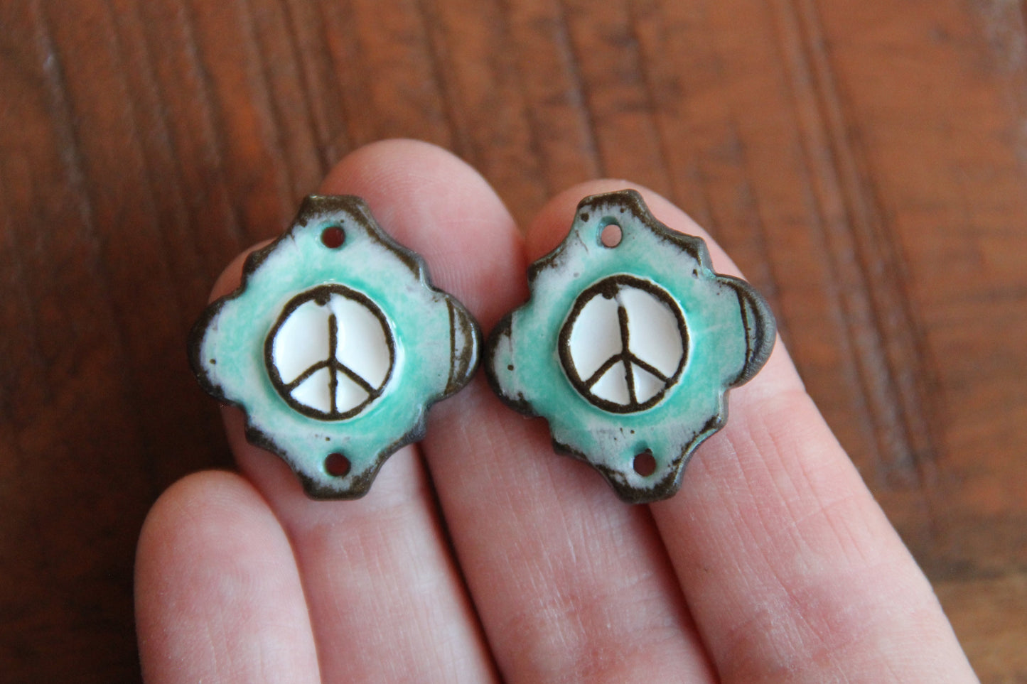 A pair of PEACE ceramic CONNECTORS