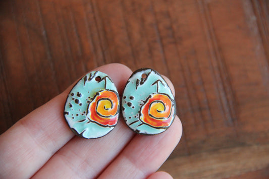 A pair of ceramic earring dangles with SPIRAL
