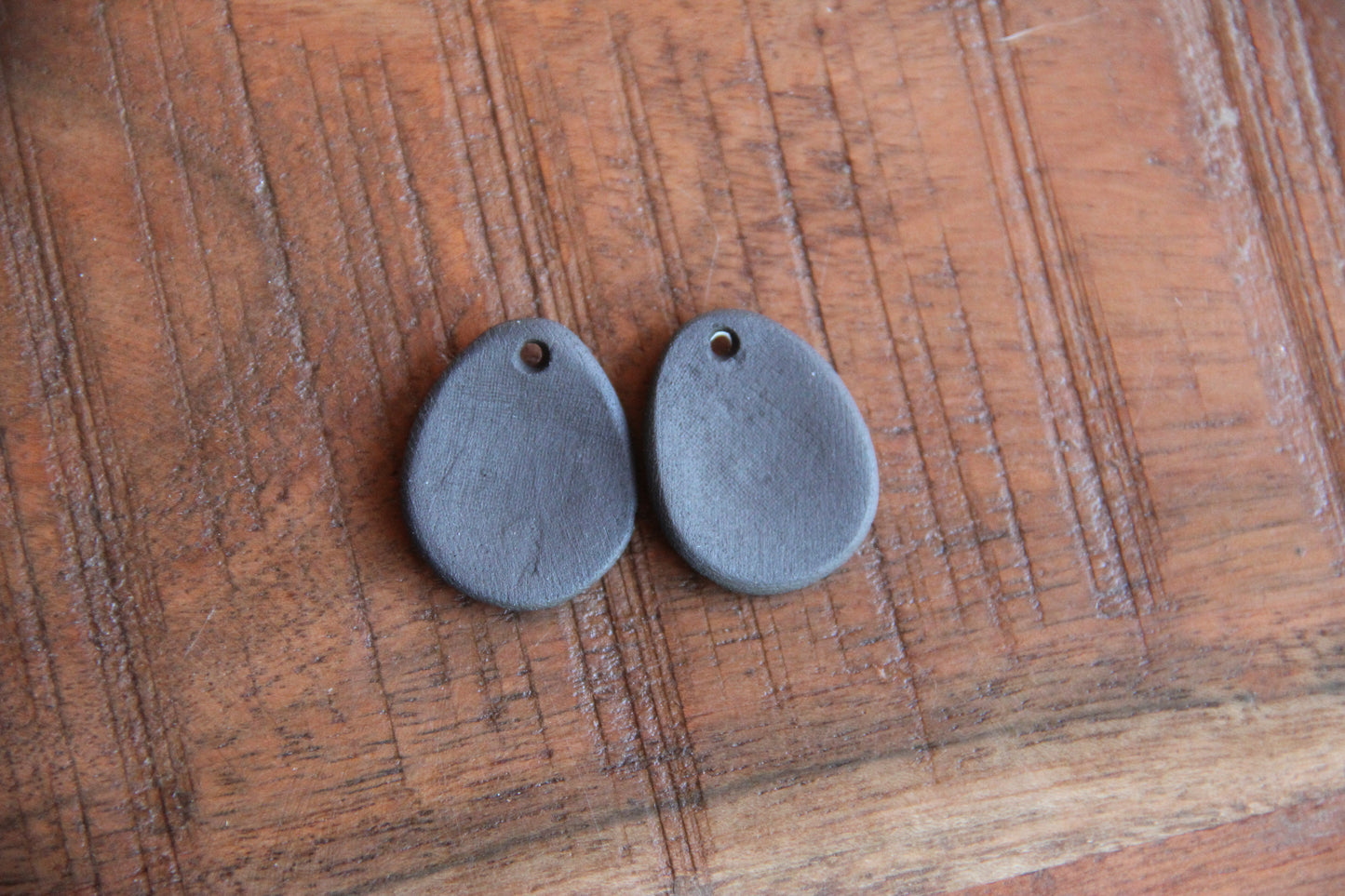 A pair of ceramic earring dangles with SPIRAL
