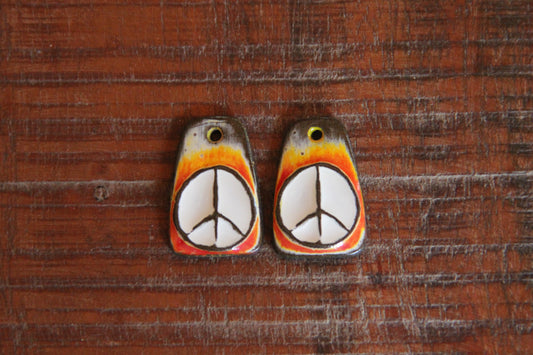 A pair of PEACE ceramic earring dangles