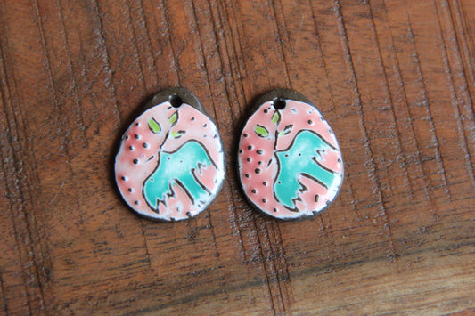 A pair of PEACE DOVE ceramic earring dangles