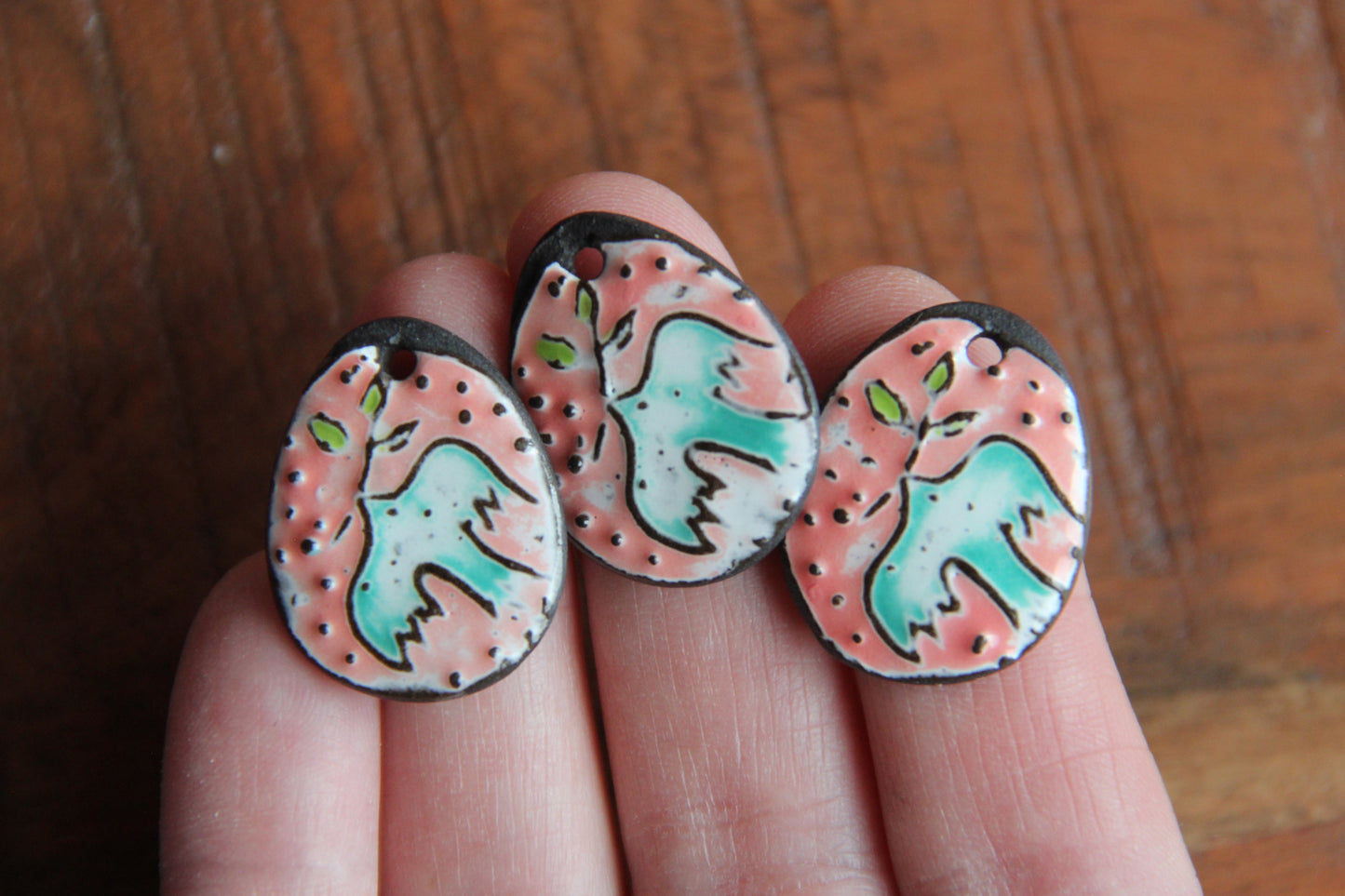 A pair of PEACE DOVE ceramic earring dangles