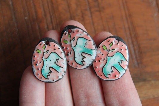 A pair of PEACE DOVE ceramic earring dangles