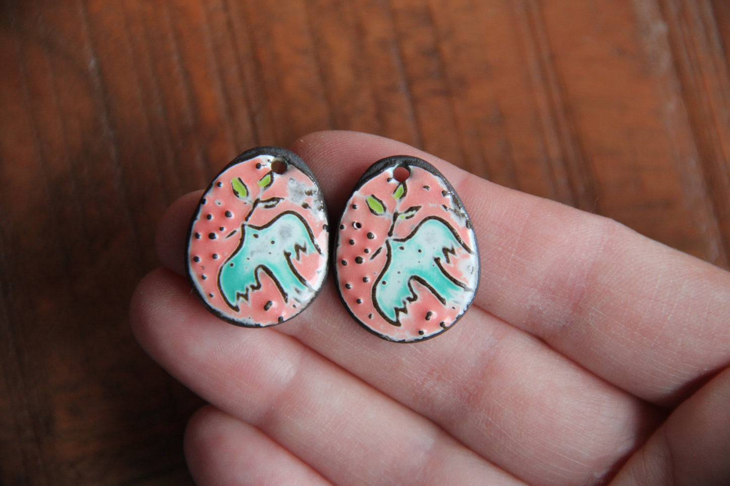 A pair of PEACE DOVE ceramic earring dangles