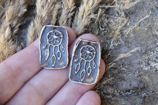 A pair of DREAMCHATCHERS ceramic earring dangles
