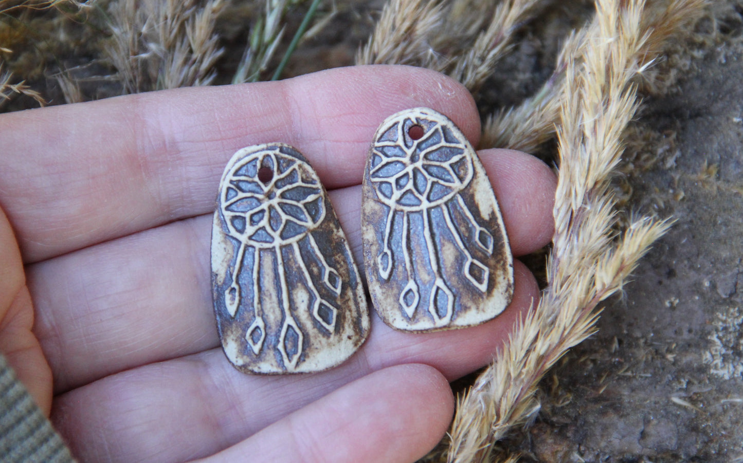 A pair of DREAMCHATCHERS ceramic earring dangles