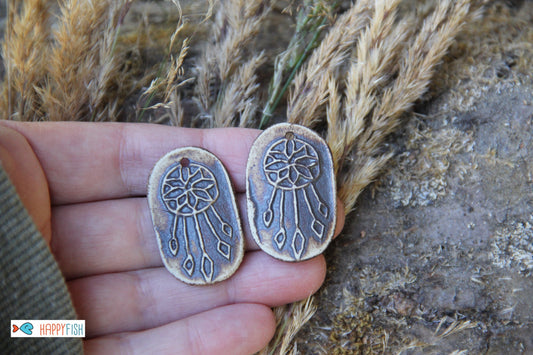 A pair of DREAMCHATCHERS ceramic earring dangles