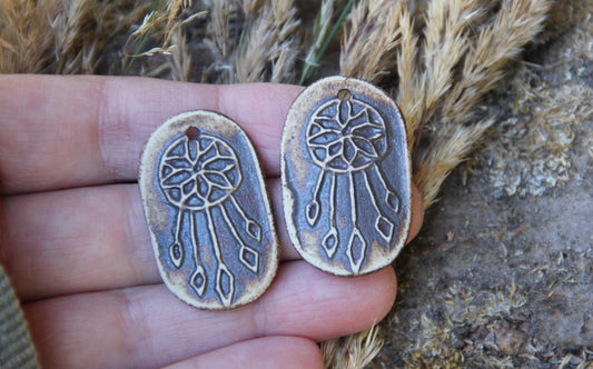 A pair of DREAMCHATCHERS ceramic earring dangles
